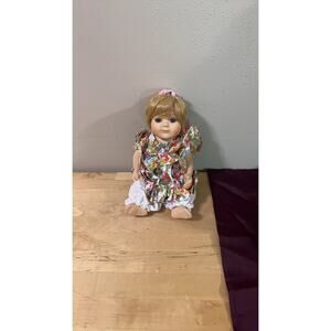 Vintage Porcelain Baby Doll with Floral Dress
